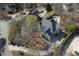 Aerial view of a home with an in-ground pool, well-kept landscaping, and a private backyard oasis at 10660 Thatcher Way, Johns Creek, GA 30097