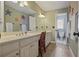 A bathroom featuring a large mirror and vanity with a connecting toilet and shower room at 10660 Thatcher Way, Johns Creek, GA 30097