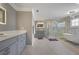 A luxurious bathroom showcasing a glass shower, standalone tub, and dual vanity at 10660 Thatcher Way, Johns Creek, GA 30097