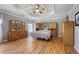 Spacious bedroom features a tray ceiling and wooden furniture set at 10660 Thatcher Way, Johns Creek, GA 30097