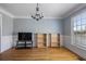 Open room with natural light. Perfect for use as a living room or dining room at 10660 Thatcher Way, Johns Creek, GA 30097