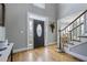 Inviting foyer with hardwood floors and a staircase leading to the upper level at 10660 Thatcher Way, Johns Creek, GA 30097