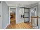 Hallway with wood floors leading to a laundry room with sliding barn door at 10660 Thatcher Way, Johns Creek, GA 30097