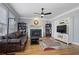 Cozy living room with a fireplace, hardwood floors, and ample seating at 10660 Thatcher Way, Johns Creek, GA 30097