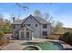 Stunning view of the rear exterior, including a luxurious in-ground pool and well-manicured landscaping at 10660 Thatcher Way, Johns Creek, GA 30097