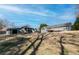 Backyard of home featuring a detached garage, wooden deck, gray siding and treed landscape at 11555 Brown Bridge Rd, Covington, GA 30016