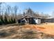 Backyard of home featuring a detached garage, covered porch and treed landscape at 11555 Brown Bridge Rd, Covington, GA 30016