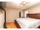 Bedroom with ceiling fan, wood floors, neutral walls and a large bed covered with white bedding at 11555 Brown Bridge Rd, Covington, GA 30016