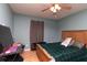 Comfortable bedroom with a ceiling fan, wood floors, a bed and a TV area at 11555 Brown Bridge Rd, Covington, GA 30016