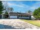 Charming single story home featuring an attached garage, a front porch, and a paved driveway at 11555 Brown Bridge Rd, Covington, GA 30016
