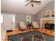 Bright living room with vaulted ceiling, hardwood floors, a fireplace and a comfortable seating area at 11555 Brown Bridge Rd, Covington, GA 30016