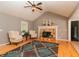 Bright living room with vaulted ceiling, hardwood floors, a fireplace and a comfortable seating area at 11555 Brown Bridge Rd, Covington, GA 30016