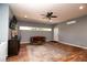 Spacious living room features wood floors, modern ceiling fan, recessed lighting and a comfortable sitting area at 11555 Brown Bridge Rd, Covington, GA 30016