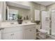 Clean, well-lit bathroom with dual sinks, white cabinetry, a glass-enclosed shower, and modern fixtures at 2272 Jamin Bnd # 13, Lithonia, GA 30058