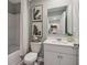 Bathroom with white cabinets, light gray walls, framed prints, and bath and shower combination at 2272 Jamin Bnd # 13, Lithonia, GA 30058