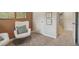 Charming bedroom featuring neutral carpet, comfortable chairs, and three framed pictures with leafy designs at 2272 Jamin Bnd # 13, Lithonia, GA 30058
