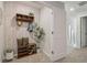 Inviting entryway with patterned wallpaper, wooden shelves, a bench, and decorative accents, offering a warm welcome at 2272 Jamin Bnd # 13, Lithonia, GA 30058