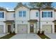 Charming townhome featuring a gray exterior, complemented by a matching one-car garage and well-maintained landscaping at 2272 Jamin Bnd # 13, Lithonia, GA 30058