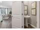 Elegant powder room featuring a pedestal sink, framed artwork, and hardwood floors at 2272 Jamin Bnd # 13, Lithonia, GA 30058