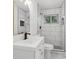 Updated bathroom with white vanity, toilet and tiled walk-in shower with black fixtures at 4378 Glenwood Pkwy, Decatur, GA 30032
