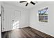 Bright bedroom with hardwood floors, white walls, ceiling fan and natural light from the window at 4378 Glenwood Pkwy, Decatur, GA 30032