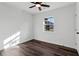 A bright bedroom with a ceiling fan, window, and dark wood flooring at 4378 Glenwood Pkwy, Decatur, GA 30032