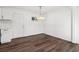 A dining room features dark wood floors and a modern chandelier at 4378 Glenwood Pkwy, Decatur, GA 30032