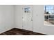 Bright entryway with a new white door, a window and stylish dark laminate flooring at 4378 Glenwood Pkwy, Decatur, GA 30032