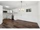 A modern kitchen features white cabinets, stainless steel appliances, and dark wood flooring at 4378 Glenwood Pkwy, Decatur, GA 30032