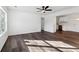 Inviting living room featuring sleek laminate flooring, a ceiling fan, and plenty of natural light at 4378 Glenwood Pkwy, Decatur, GA 30032