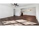 Open-concept living room with laminate flooring, a modern ceiling fan, and ample natural light at 4378 Glenwood Pkwy, Decatur, GA 30032
