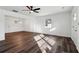 Spacious living area boasts gorgeous laminate flooring, a modern ceiling fan, and neutral paint at 4378 Glenwood Pkwy, Decatur, GA 30032