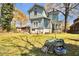 A large, sunny backyard with a two-story house featuring a mix of siding and a well maintained lawn at 561 Culberson Sw St, Atlanta, GA 30310
