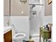 Bathroom features white tile, updated shower, and vintage vanity at 561 Culberson Sw St, Atlanta, GA 30310