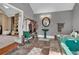 Unique bathroom with a sunken teal tub, stone floors, open closet, and pedestal sink at 561 Culberson Sw St, Atlanta, GA 30310