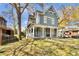 Lovely blue two-story house featuring a large front porch, balcony, and lush lawn at 561 Culberson Sw St, Atlanta, GA 30310