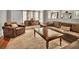 Open concept living room area featuring hardwood floors, comfortable leather furniture, and a large coffee table at 561 Culberson Sw St, Atlanta, GA 30310