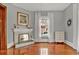 Comfortable living room with hardwood floors, a fireplace, and large windows with white curtains at 561 Culberson Sw St, Atlanta, GA 30310