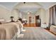 Spacious main bedroom suite with a seating area, fireplace, and neutral color palette at 561 Culberson Sw St, Atlanta, GA 30310
