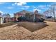 A backyard scene with a view of the house and surrounding trees, showing the potential for outdoor activities at 1050 Sunny Field Ct, Lawrenceville, GA 30043