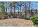 A backyard featuring a playset and surrounded by trees, offering a recreational space for outdoor enjoyment at 1050 Sunny Field Ct, Lawrenceville, GA 30043