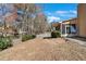 A backyard featuring a grassy area, trees, and a view of the screened-in porch, ideal for outdoor enjoyment at 1050 Sunny Field Ct, Lawrenceville, GA 30043