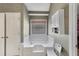 Bathroom featuring a window, cabinet, and bathtub at 1050 Sunny Field Ct, Lawrenceville, GA 30043