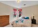 Bedroom features a full bed, dresser, and natural light at 1050 Sunny Field Ct, Lawrenceville, GA 30043