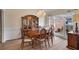 Formal dining room featuring hardwood floors, a chandelier, and natural light from large windows at 1050 Sunny Field Ct, Lawrenceville, GA 30043