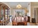 Formal dining room featuring hardwood floors, a chandelier, and natural light from large windows at 1050 Sunny Field Ct, Lawrenceville, GA 30043