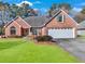 Charming single-story brick home with a well-manicured lawn and attached two car garage at 1050 Sunny Field Ct, Lawrenceville, GA 30043