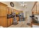 Kitchen with stainless steel appliances, wood cabinets, granite countertops, and ceiling fan at 1050 Sunny Field Ct, Lawrenceville, GA 30043