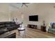 Spacious living room with neutral walls, ceiling fan, wood floors, and comfortable furniture at 1050 Sunny Field Ct, Lawrenceville, GA 30043