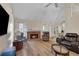 Bright living room features a fireplace, high ceilings, wood floors, and a ceiling fan at 1050 Sunny Field Ct, Lawrenceville, GA 30043